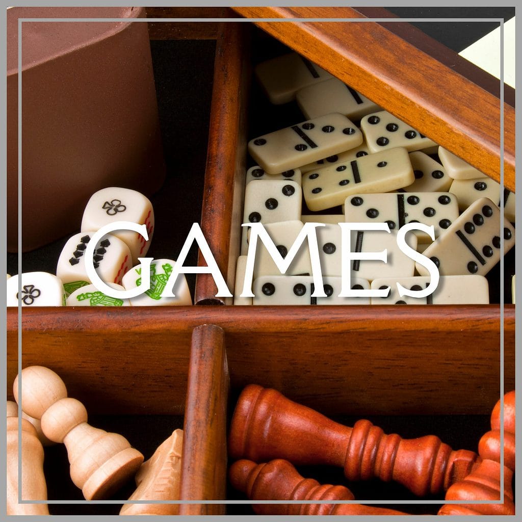 photo of game box with dominoes, dice and chess pieces